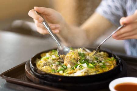 seafood omelet in hot pan ,street food in bangkokの写真素材