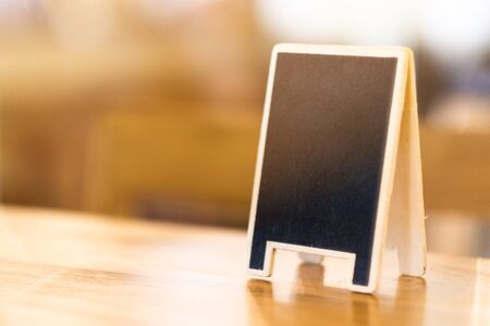 Mini chalkboard on table in cafe with copy spaceの写真素材