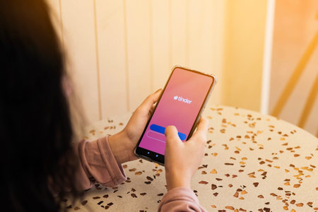 A girl using Tinder application on smartphones, Bangkok, Thailand, Nov 26, 2019