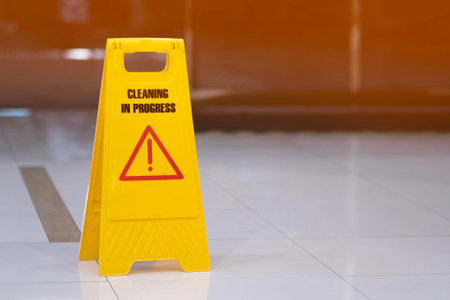 yellow sign of caution reserve cleaning on the wet floorの写真素材