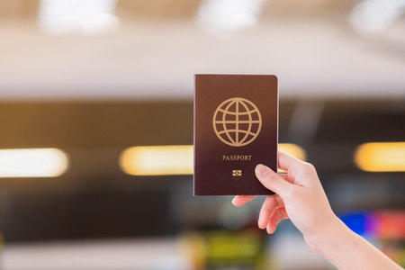 A traveler holding passport in airportの写真素材