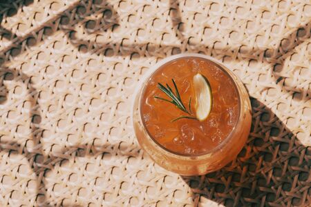 A glass of ice tea on bamboo tableの写真素材