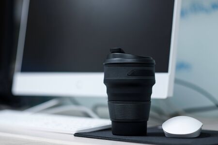 Black silicone coffee mug in officeの写真素材