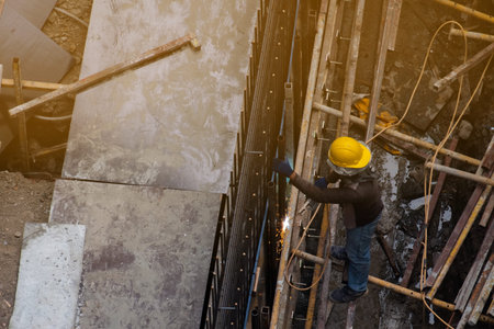 Construction workers welding steel