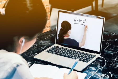 Students girl study from online classes by laptop computer in her house の写真素材