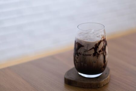 A glass of milk chocolate in cafeの写真素材