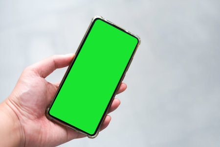 Man holding Green screen smartphones 