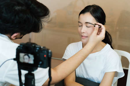 Markup artist and Asian girl beauty blogger online live streamingの写真素材