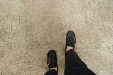 A man walking with black shoes on the streetの写真素材