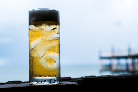 A glass of beer and sea  background