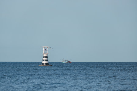 Light house and boat on the seaの写真素材