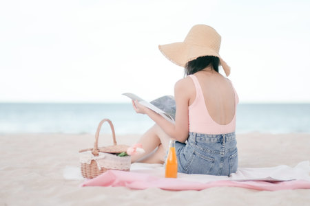 Asian woman Picnic on the beachの写真素材