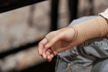 Women using a Tubular Bandage for provide tissue support in treating strainsの写真素材