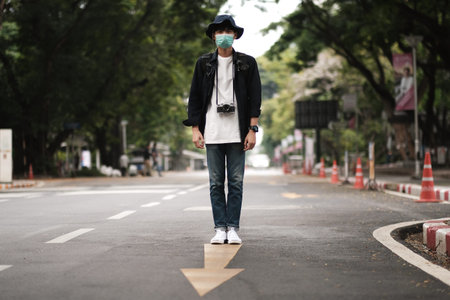 Asian travelers man in the street with medical face mask to protection  new normal lifestyleの写真素材
