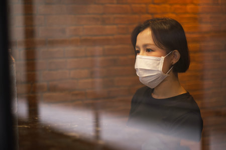 Asian women and face mask felling headeach