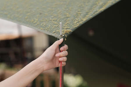 A woman pitching a camping tentの写真素材