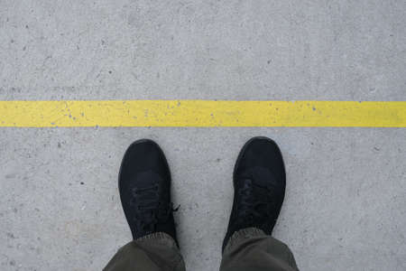 A man with black shoe and yellow lineの写真素材