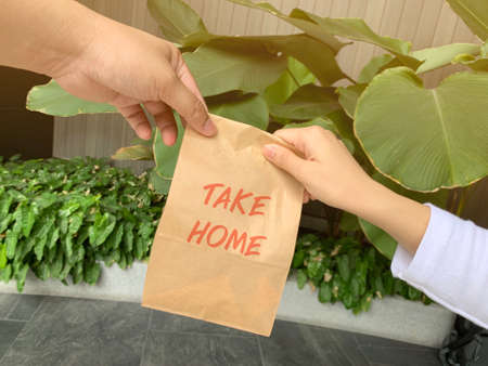 A woman order some food take home for eating in house during self quarantined, COVID-19 crisisの写真素材