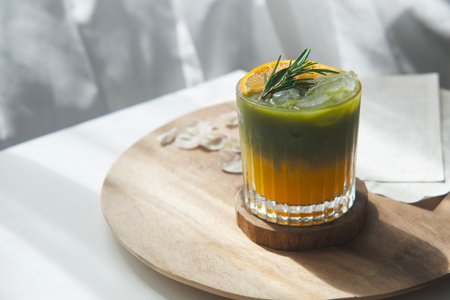 A glass of iced orange matcha green teaの写真素材