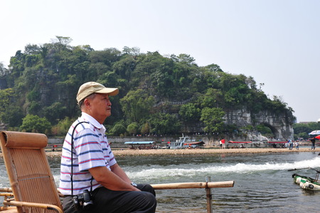 an old man enjoy the Guilin Sceneryのeditorial素材