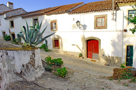 Portugal, area of Alentejo, Marvao: Typical house; view of the main facade of a typical south white house with red door and red windows の写真素材