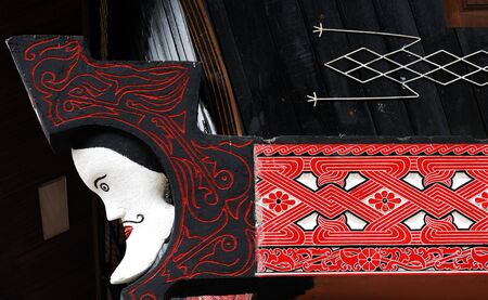 Indonesia, Sumatra:detail of a wood typical painting and carved  decoration of Indonesian housesの写真素材