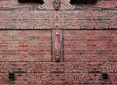Indonesia, Sumatra:detail of a wood typical painting and carved  decoration of an Indonesian houseの写真素材