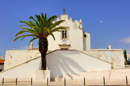 Portugal, area of Algarve, Albufeira: typical religious architecture. blue sky and detail of a white  churchの写真素材