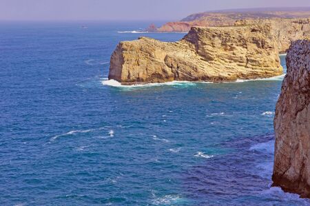 Portugal, area of Algarve, Sagres: Cabo de S Vincente.Portugal, area of Algarve, Sagres: Wonderful coastline; blue sky, blue water and yellow stone coast. Cabo de S Vincente the extreme occidental pointe of Europeの写真素材