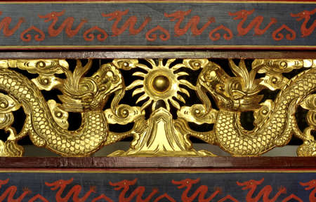 China; shangai; temple decor; traditional design for these wooden carved dragons in gold leaf   の写真素材