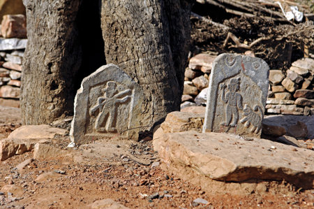 India, Chittorgarh: Tombs near Chittorgarh; red sand and small carved stones with figures の写真素材