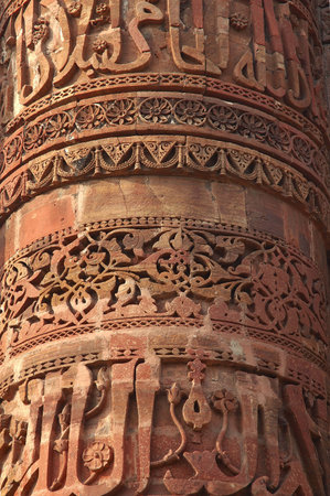 India, Delhi: Qutab minar; close-up of the tallest brick minaret in the world; with 72,5 m;  the minaret is decorated with carved writting; this monument is listed as unesco world heritageの写真素材