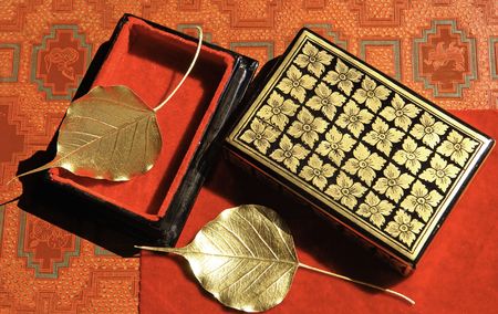 Myanmar, Mandalay: Handicraft, golden leaves with a traditional box  on a red background の写真素材