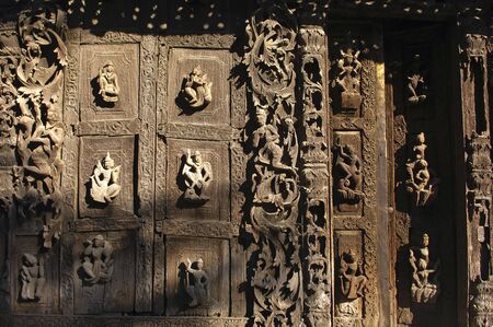 Myanmar, Mandalay: Pagoda; detail of the ancient architecture of this wood monastery; carved religious figuresの写真素材