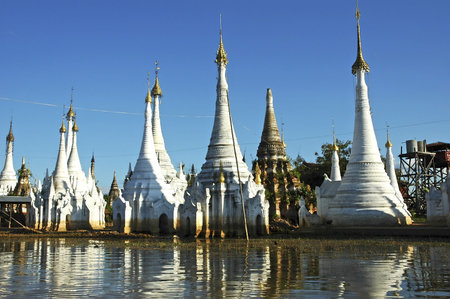 Myanmar, Inle lake:  white stupas near the floating market and their shadows on the waterの写真素材
