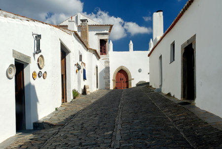 Magnificent village of Monsaraz, traditional  street with small white houses and red tiles a typical view from the south of the countryの写真素材