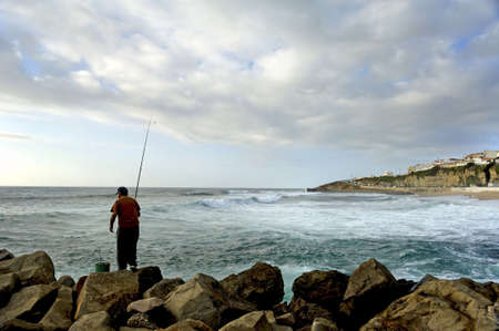 Portugal, Ericeira: blue sky and the atlantic ocean for this  fishing image during  the sundownの写真素材