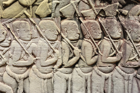 The Bayon was constructed during the reign of Jayavarman VII and Jayavarman VIII (13th century). The temple is one of the most enigmatic religious constructions in the world. Here a representation of the infantry  の写真素材