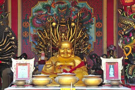 In Thailand the city of Ayutthaya was founded in 1350 today is an impressive archaeological park; here a view of seated Buddha on a Chinese temple on the back of Wat Phanan-Choeng の写真素材