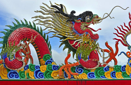 In Pattaya, Thailand, the Anek Kusala Viharasien temple and museum is a repository of art and religious statues from Thailand and China. Here a carved and painted Chinese dragon on the roofs.の写真素材