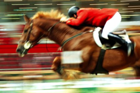 View of a jumping race horse and his rider during a competitionの写真素材