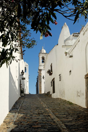 Portugal, Alentejo: Magnificent village of Monsaraz; traditional  street with small white houses and red tiles a typical view from the south of the countryの写真素材
