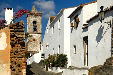 Portugal, Alentejo: Magnificent village of Monsaraz; traditional  street with small white houses and red tiles a typical view from the south of the countryの写真素材