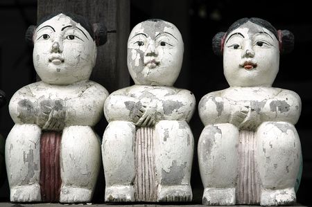 Thailand, Chiang Mai: three seated statues in the gardens of a buddhist templeの写真素材