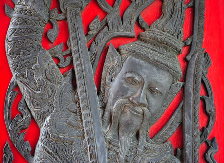 Thailand, the Wat Benchamabophit or the Marble temple in the city of Bangkok constructed in 1900 is faced with white Carrara marble. View of the window decoration with an warriorの写真素材