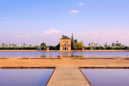 Morocco, Marrakech, Marrakesh: Menara garden; blue sky and blue waters dominated by the pond viewの写真素材