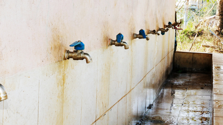 Old faucet at the male bathroomの写真素材