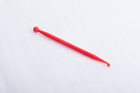 A red plastic sculpting tool on a white surfaceの写真素材
