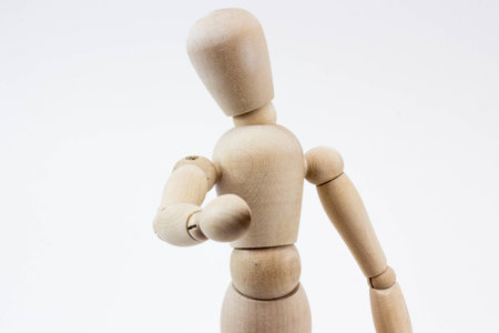 The upper body of a wooden mannequin pointing at us, in front of a white background.の写真素材