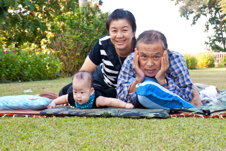 An Asian family playing in the park